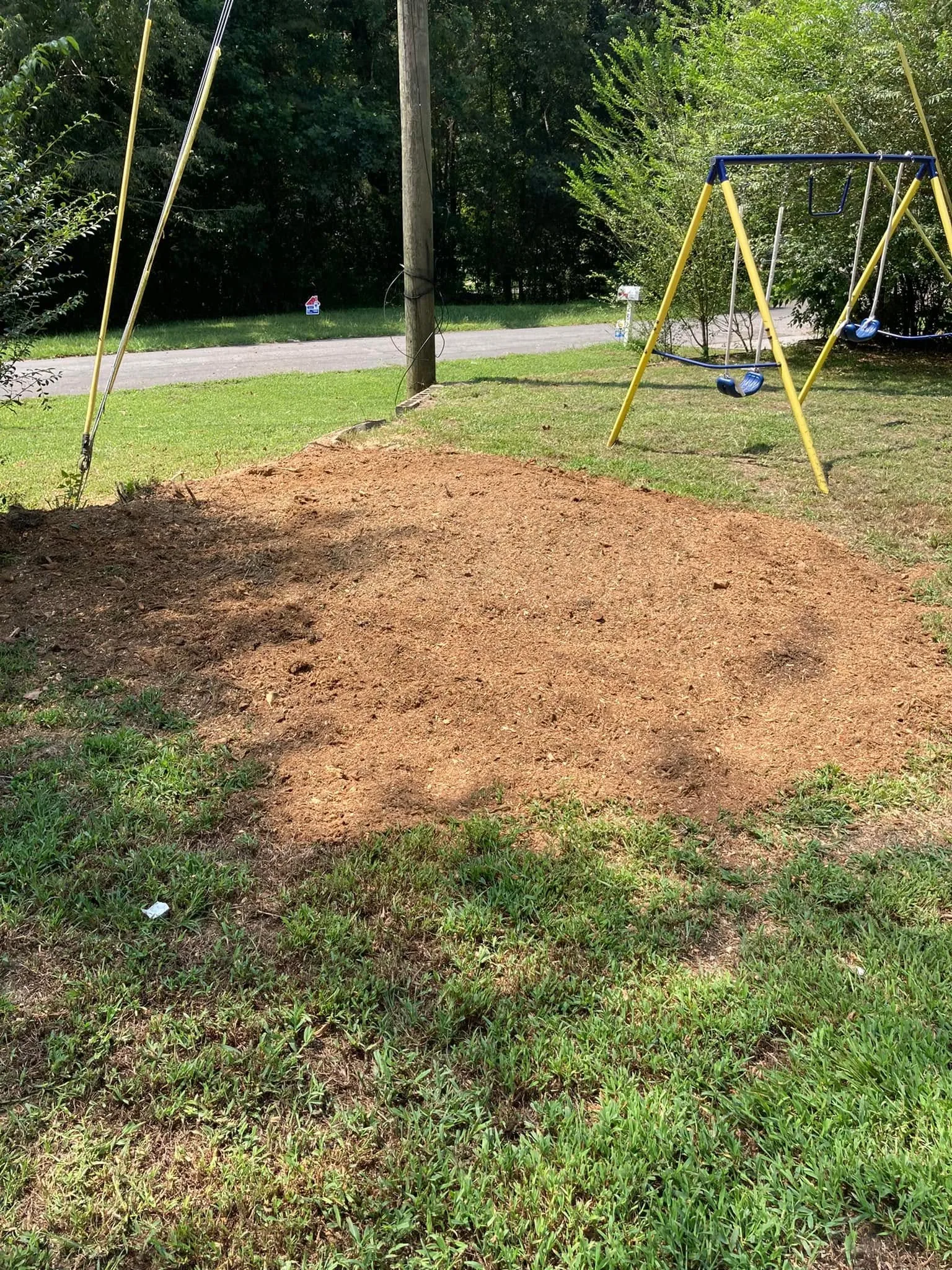 Same yard with stump ground below grade, ready for seed.